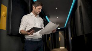 Property manager reviewing upgrade plan in mechanical room