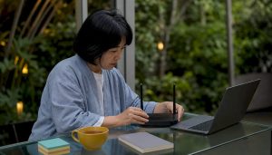 Person setting up wireless router in home office